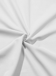 Close-up of white waffle knit polo fabric showing breathable mesh texture and soft drape