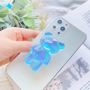 Close-up of holographic 3D bear griptok phone stand with rainbow reflection effects