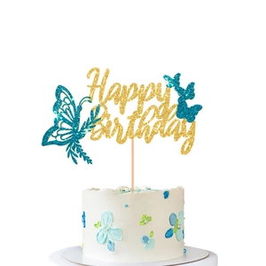 Close-up of golden glitter Happy Birthday cake topper with teal glitter butterflies
