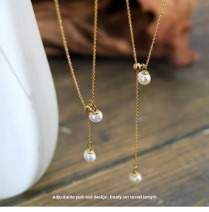 Detail of adjustable gold Y-necklace with freshwater pearls and sliding tassel mechanism