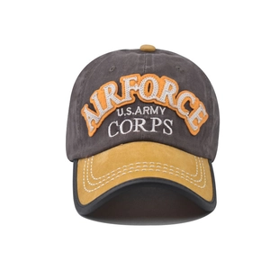 Detail of embroidered military patches on cotton canvas baseball cap with yellow brim