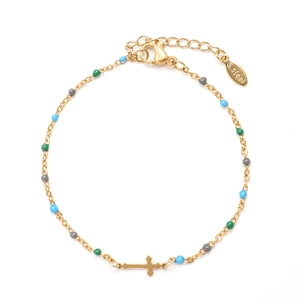 Detailed macro of gold stainless steel cross bracelet with colorful enamel beads