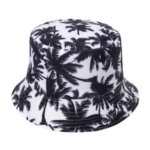 Reversible bucket hat with black palm tree print on breathable white cotton canvas