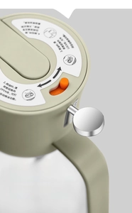 Close-up of dual-mode oil sprayer lid with orange switch and ergonomic handle detail
