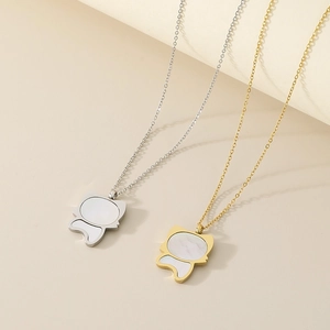Detailed close-up of gold and silver kitten necklaces with white mother of pearl inlay