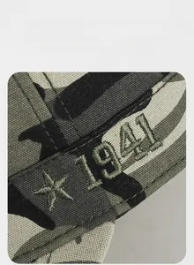 Detail of army green camouflage cap featuring vintage star and 1941 embroidery
