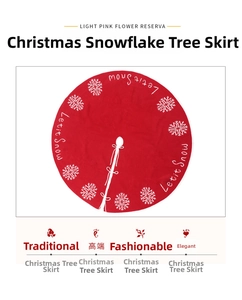 Detail of red Christmas tree skirt featuring white snowflake patterns and Let it Snow text