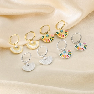 Detailed view of vintage gold fan-shaped earrings with colorful enamel on silk