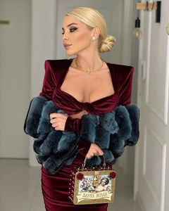 Robe élégante en velours bordeaux à manches longues avec châle en fourrure et sac doré