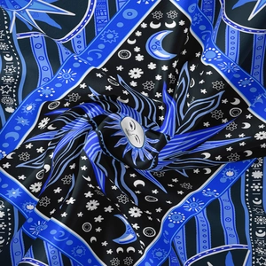 Detail of bohemian sun and moon tapestry with satin sheen and mystic astrology print
