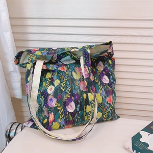 Detailed close-up of vibrant oil painting floral print on artistic canvas tote bag