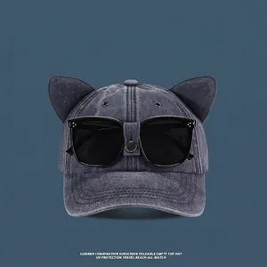 Detail of grey washed denim baseball cap with cat ears and integrated black sunglasses