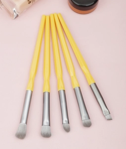 Detail of 5-piece diamond handle eye makeup brush set with yellow faceted grips