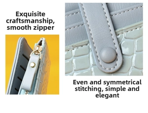 Detail view of light blue crocodile embossed leather wallet with golden zipper and stitching