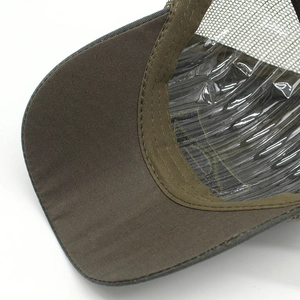 Detail view of olive green mesh baseball cap featuring reinforced stitching on the canvas brim