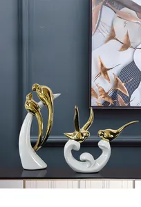 Detail of luxury white and gold ceramic bird figurines for modern home interior decor
