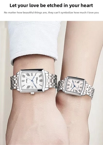 Close-up of elegant couple watch set with Roman numerals and silver steel bands