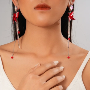 Red bow fringe earrings with rhinestones on model, sparkling tassel jewelry piece