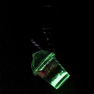 Glow-in-the-dark mini fruit cup keychain with green luminous effect and purple straw