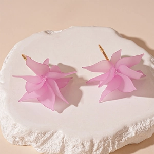 Detailed macro view of pink matte resin flower petals and golden earrings attachment