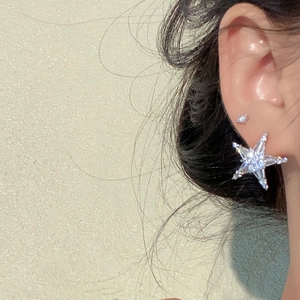 Silver starfish stud earrings set with sparkling cubic zirconia on a model side profile