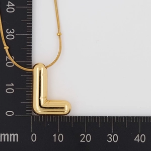 Detailed size measurement of polished golden balloon letter L pendant on a scale