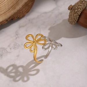 Detailed macro view of an adjustable floral open ring with elegant gold and silver finish
