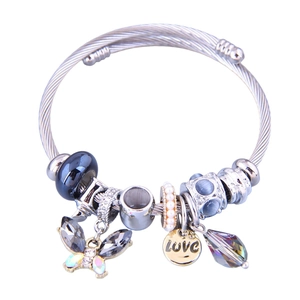 Detail of silver beaded wrap bracelet with blue beads, butterfly charm and LOVE pendant