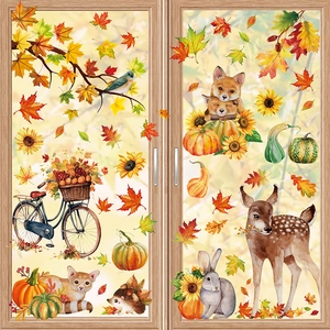 Detail of autumn window clings with fox, pumpkin, and maple leaf motifs on glass