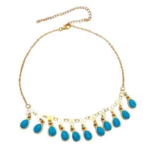 Detail of bohemian gold necklace featuring blue teardrop charms and adjustable lobster clasp