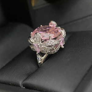 Macro shot of 18k silver plated floral ring with a large pink oval gemstone and crystals