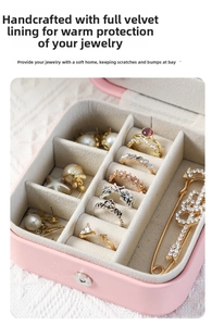 Pink leather jewelry box interior with velvet ring slots and pearl earring compartments
