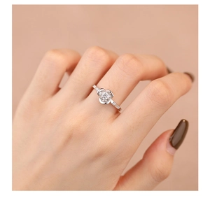 Close-up of S925 sterling silver rose ring with pavé zircons worn on model finger