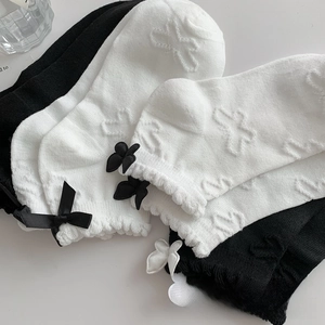 Close-up of lolita style cotton socks with butterfly patterns and satin bows