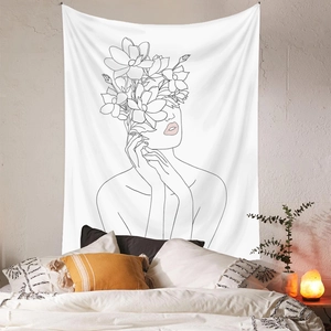 Detail of minimalist line art tapestry with female silhouette and floral design on bedroom wall