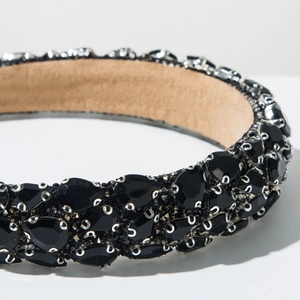 Close-up of baroque headband featuring black crystals with silver claw settings and suede lining