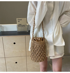 Detail of hand-woven straw bucket bag with wave texture and drawstring inner lining