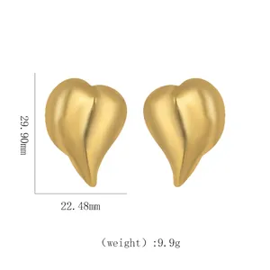 Detailed view of large heart-shaped matte gold earrings with precise size measurements