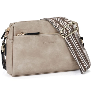 Detail of beige leather crossbody bag with dual zippers and colorful woven strap