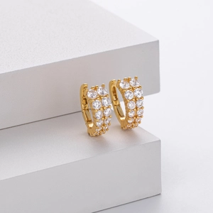 Detail of gold S925 silver earrings with double-row micro-set clear zircon crystals