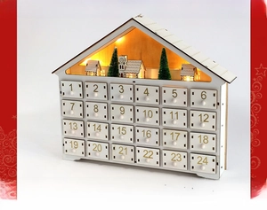 Macro view of wooden advent calendar with 24 small drawers and warm LED light decoration