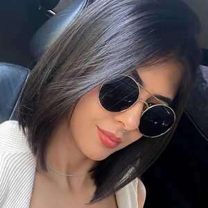Woman wearing vintage metal double bridge round sunglasses and crescent nose ring