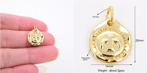 Detailed view of bird relief gold round pendant with dimensions 20mm by 14mm