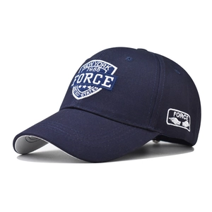 Macro detail of the white 1985 FORCE 3D embroidery on the navy blue cotton cap