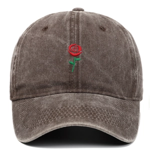 Close-up of a rose embroidery on a vintage washed cotton baseball cap with fabric texture