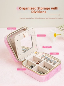Pink velvet travel jewelry box with multiple compartments and built-in mirror