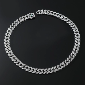 Macro shot of silver hip-hop Cuban link chain featuring a crystal-set dollar sign clasp