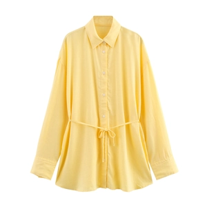 Detailed flat lay of a yellow long sleeve linen shirt with waist tie design and buttons