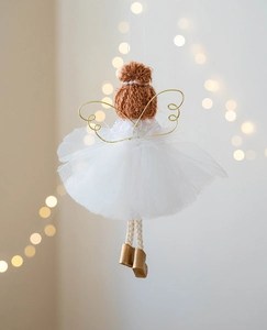 Detailed view of handmade angel ornament with white mesh skirt and golden wings