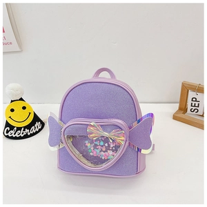 Detail of purple sequin heart pocket and glitter fabric on kids wing backpack